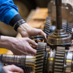 Technician repairing disassembled gear box