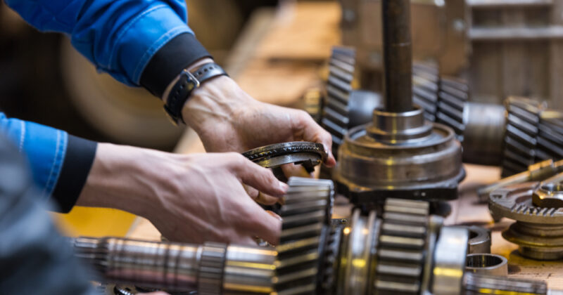 Technician repairing disassembled gear box