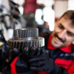 Technician inspecting gear for quality