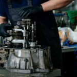 Technician repairing a disassembled gearbox.